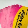 Stack of pink and yellow promotional mailers addressed to Linteng with text Hello Linteng heres a cheeky fiver for you and...